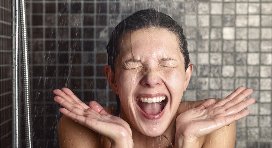Young,Woman,Reacting,In,Shock,To,Hot,Or,Cold,Shower