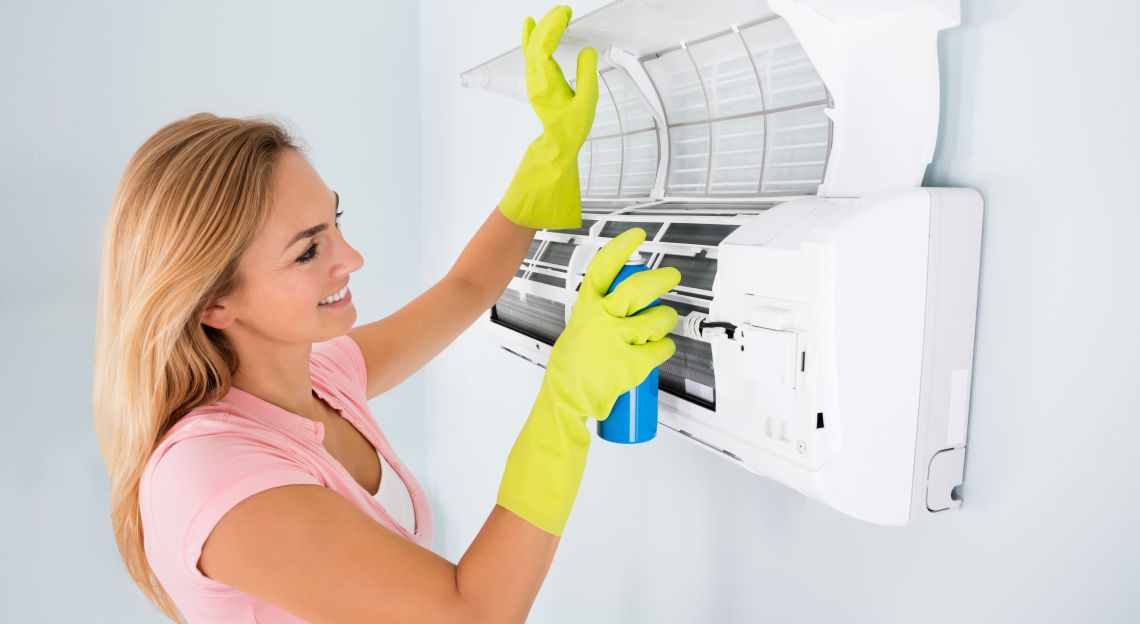 Young,Happy,Woman,Cleaning,The,Air,Conditioner,With,Spray,Bottle