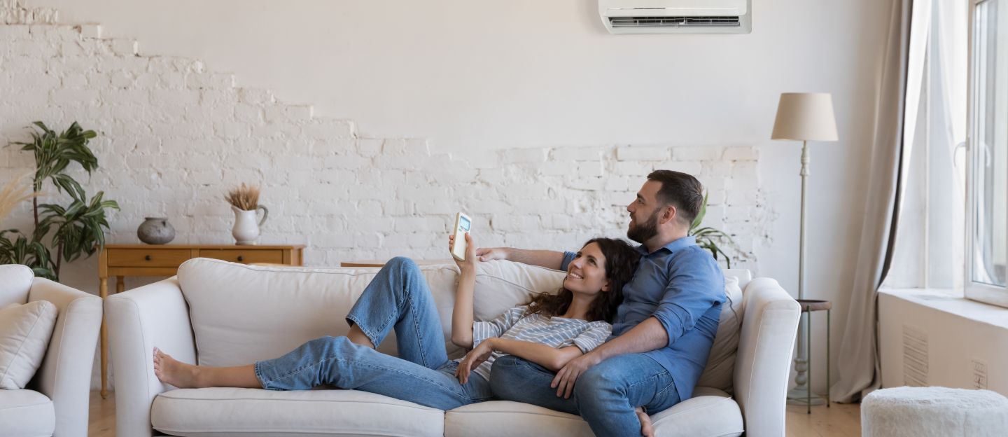 Happy,Millennial,Couple,Of,Homeowners,Enjoying,Cool,Conditioned,Air,,Resting