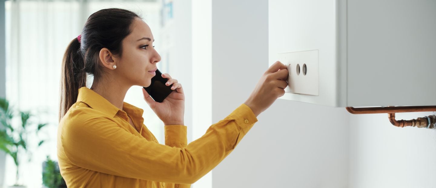 Worried,Woman,Calling,A,Boiler,Breakdown,Emergency,Service,Using,Her