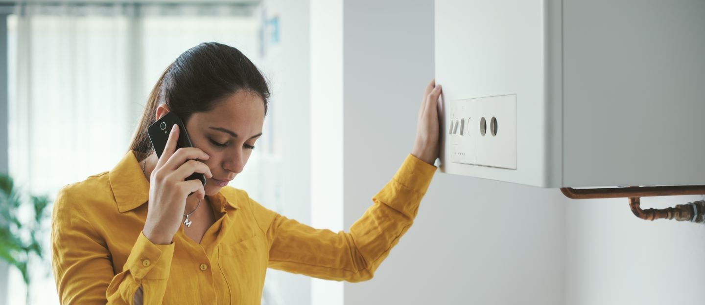 Worried,Woman,Calling,A,Boiler,Breakdown,Emergency,Service,Using,Her