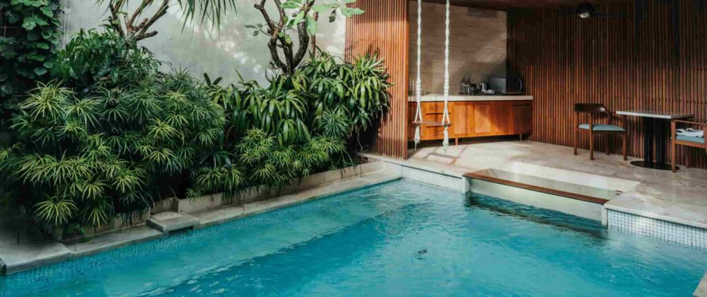 kolam renang minimalis dengan ayunan, dapur kecil, dan meja kursi kolam renang minimalis dengan ayunan, dapur kecil, dan meja kursi